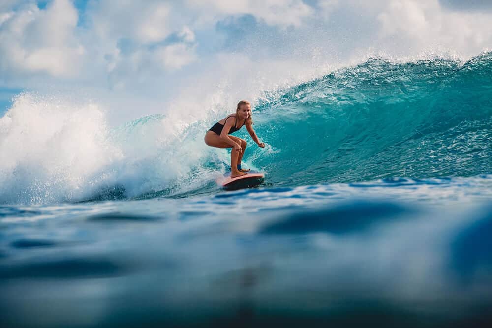 A women riding the ocean waves on a surfboard